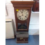 An early 20th century oak clocking in machine, together with a wall hanging bank of cards