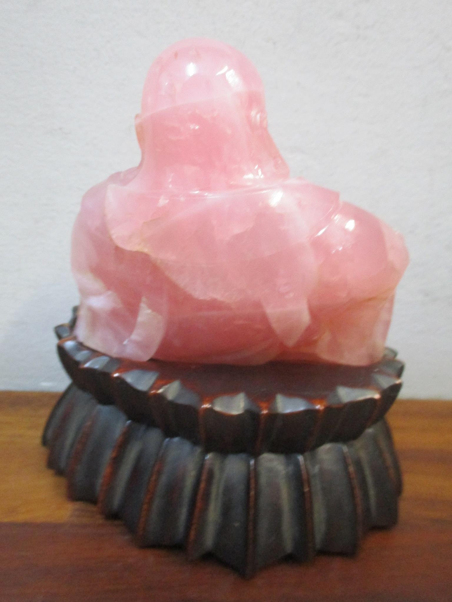 A carved pink stone model Buddha on a carved wooden base Location: - Image 2 of 2