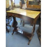 A Victorian mahogany work table with a hinged top over a false drawer and wool well slide, over lyre