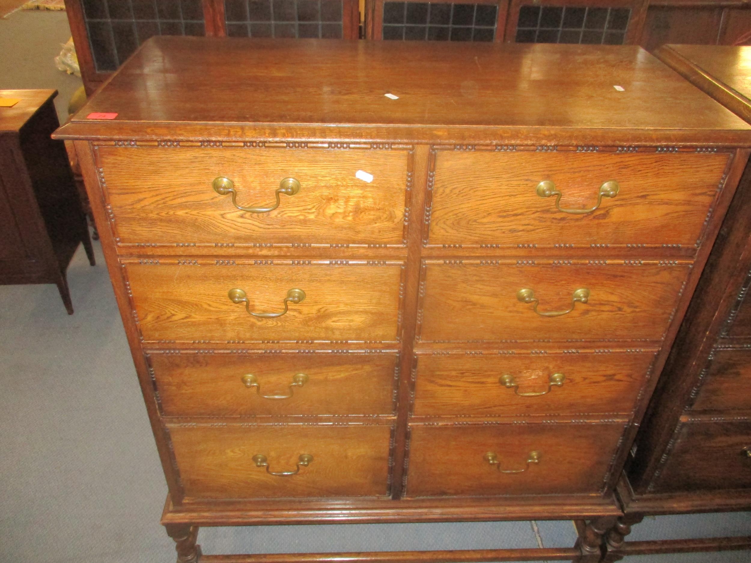 An early 20th century oak side chest of eight short drawers with brass swan neck handles, sausage - Image 3 of 5