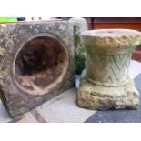 A carved stone font with turned stone pillar, the font having carved images of six pointed stars and