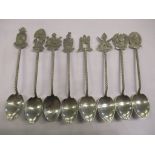 A set of eight white metal spoons decorated with emblems to the handle tips, 69.1g Location: