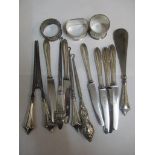Silver handled knives, two silver handled button hooks, three silver napkin rings and a set of three