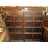A pair of early 20th century oak glove Wernicke style book bookcases with leaded glass doors, on