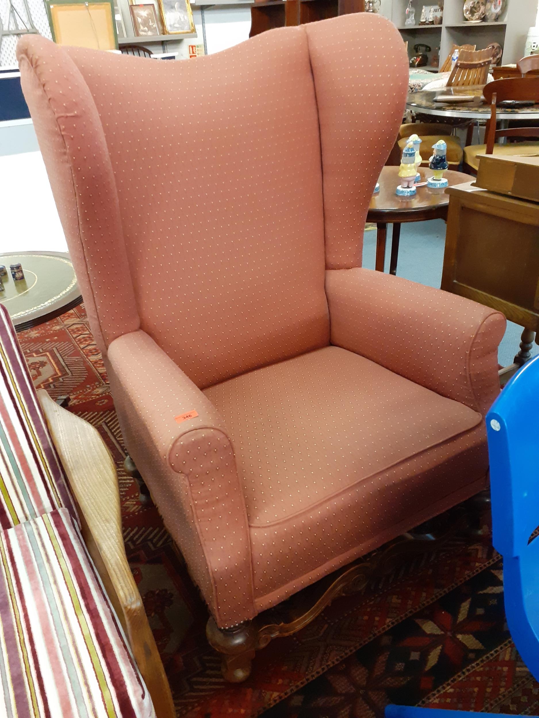 A Victorian wingback armchair in rose pink upholstery. Location:Back Row