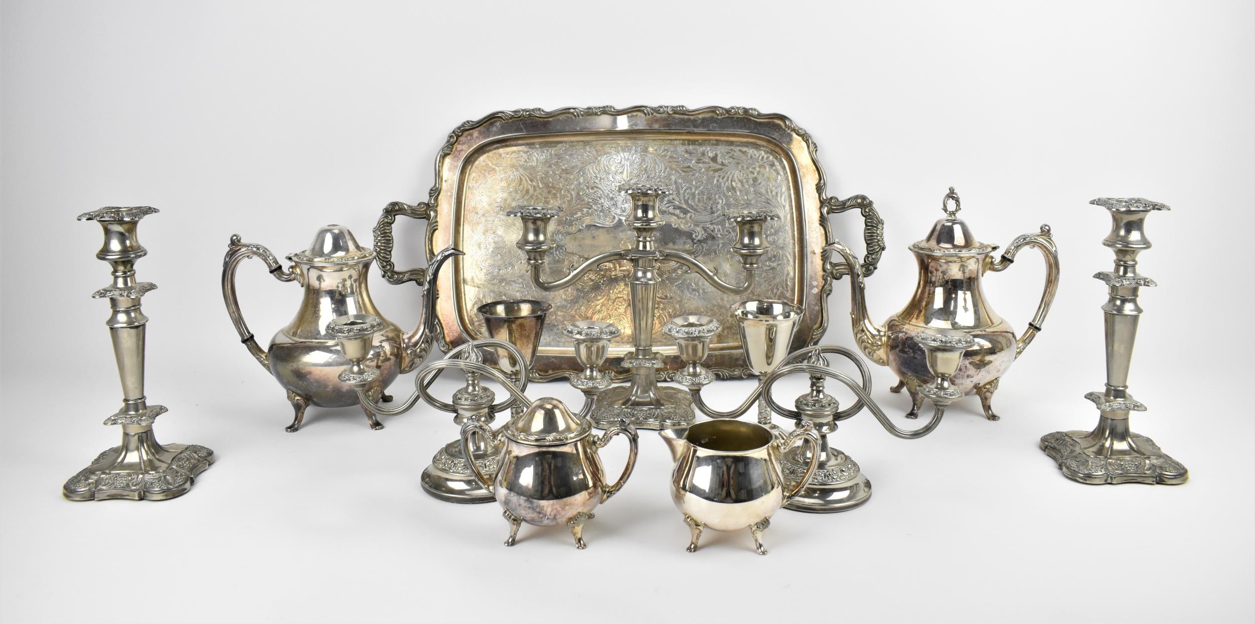 A collection of silver plated wares to include a large Oneida twin handled tray with scrolled border