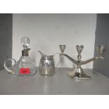 Mixed white metal items to include a cream jug, candelabrum and a glass bottle with metal rim