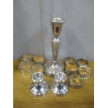 Silver to include a pair of dwarf candlesticks, a weighted candlestick, five napkin rings and a