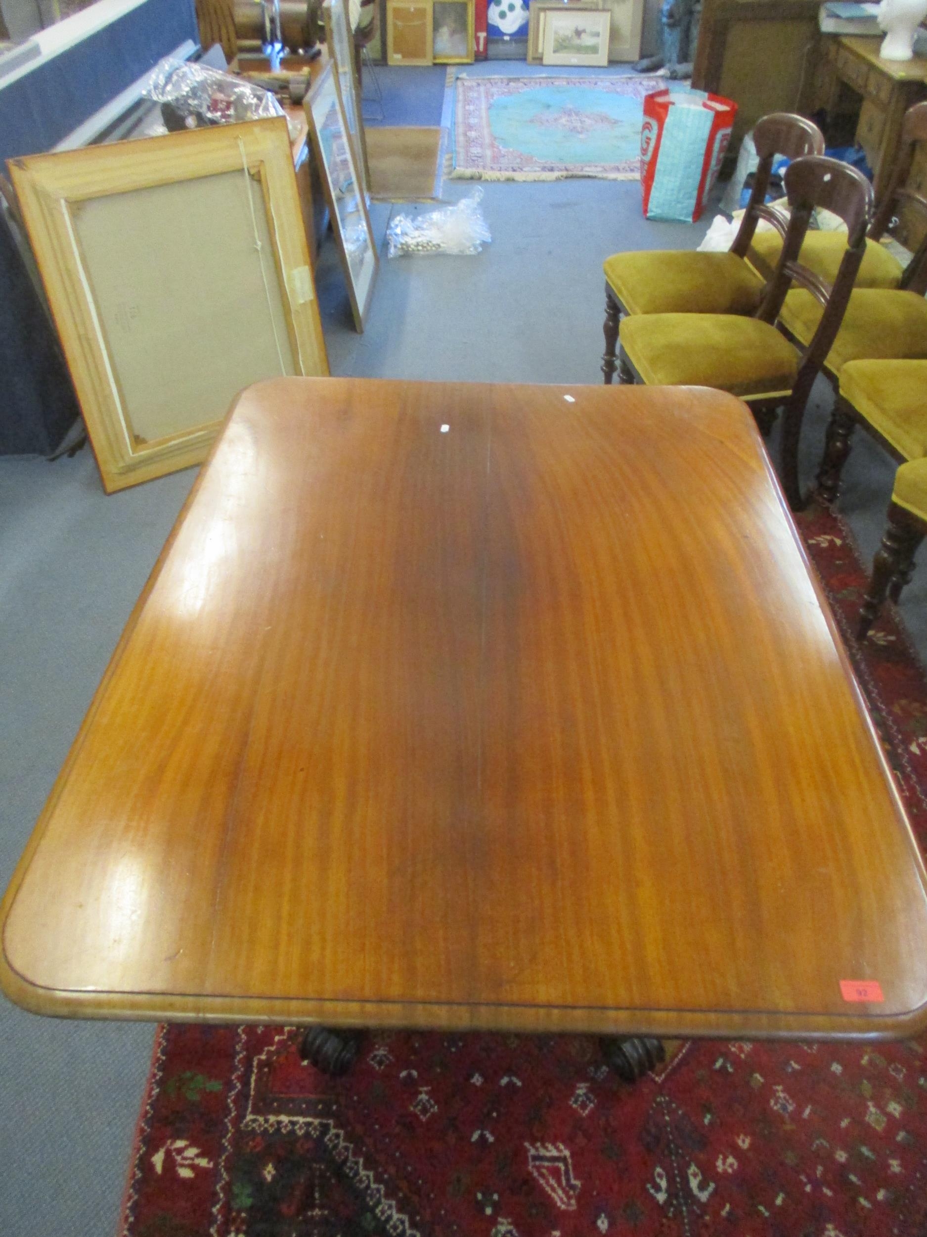 A Regency mahogany tilt top breakfast table, the rectangular top with rounded corners and moulded