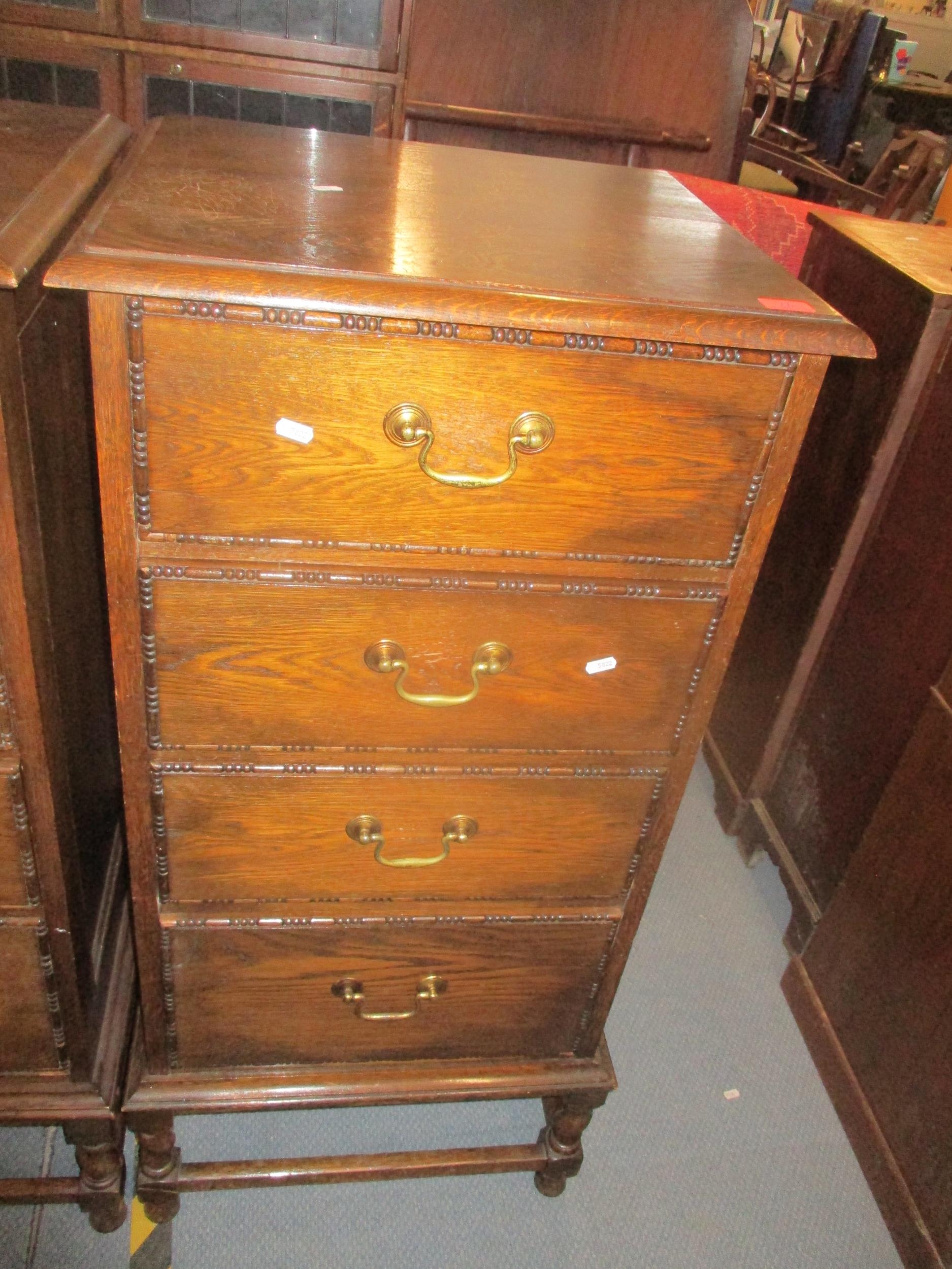 An early 20th century oak side chest of eight short drawers with brass swan neck handles, sausage - Image 4 of 5