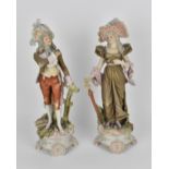 A pair of late 19th century Royal Dux porcelain figures, modelled as a lady and gentleman, in lace