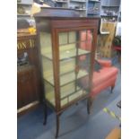 A late Victorian/Edwardian display cabinet, shaped extended back, glazed door with central inlaid