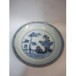A Nanking Cargo saucer decorated with a garden scene in blue and white Location: