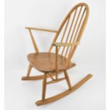 An Ercol blonde elm rocking armchair designed by Lucian Ercolani, quaker model 428, in the windsor