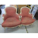 A pair of 20th century French style white panted armchairs Location: