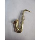 A 9ct gold brooch fashioned as a saxophone set with diamonds, 4.95g Location: