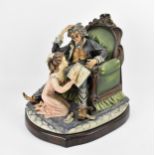 A large Capodimonte porcelain group by Germano Cortese, 'The Young Story Teller', signed to the back