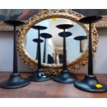 Four vintage black painted wrought iron candlesticks, together with a gilt framed oval wall
