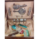 A vintage crocodile case and contents of silver topped glass bottles and a silver backed dressing