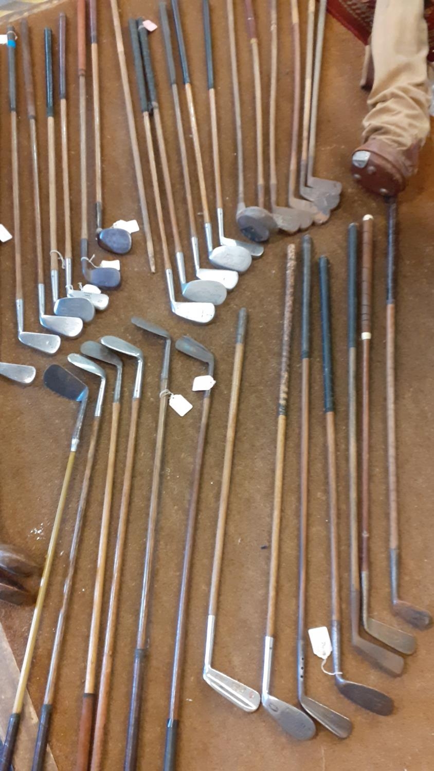 A quantity of vintage wooden and iron golf clubs to include an early 20th century Jack White, a