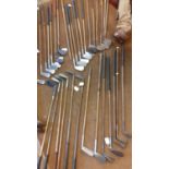 A quantity of vintage wooden and iron golf clubs to include an early 20th century Jack White, a
