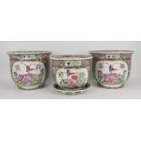 A set of three Chinese 20th century porcelain jardinieres, each decorated profusely with enamelled