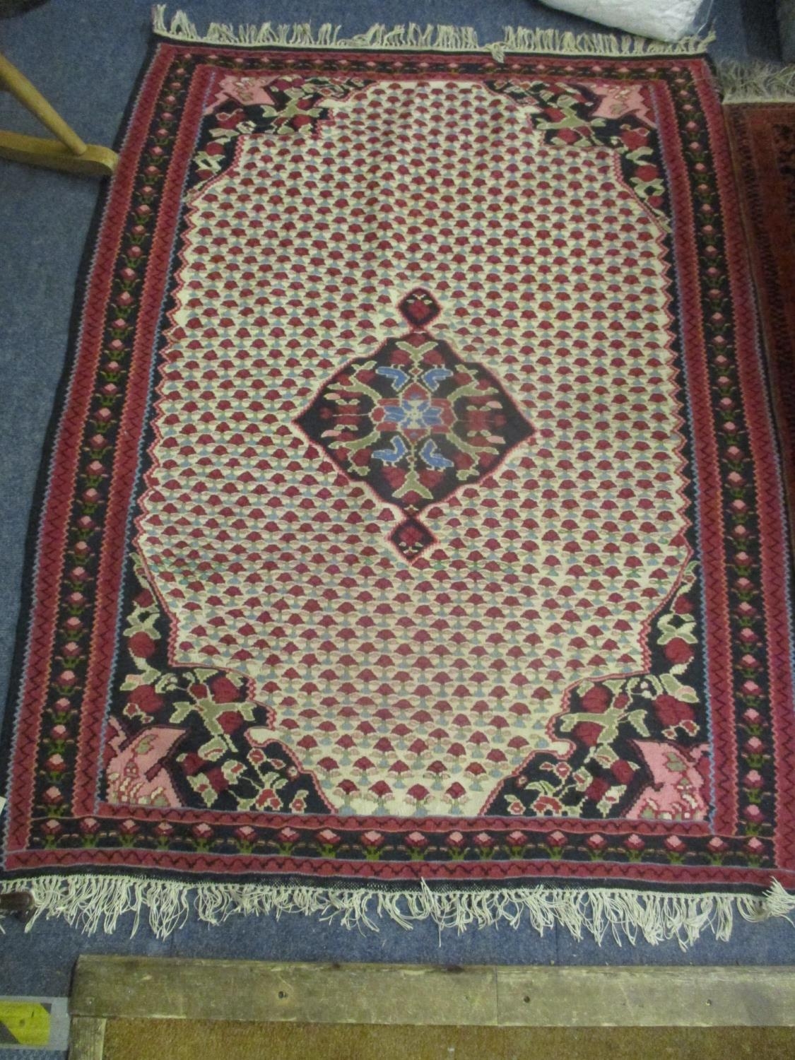 Two rugs to include one having a pink ground with a central motif and tasselled ends, 152 x 114.5 - Image 2 of 2