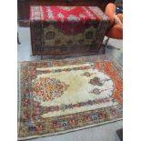 Two rugs to include a Persian beige ground rug with lamp ornament and multiguard borders 186cm x