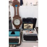 A cased Silver Reed and a cased Liliput typewriter, along with a carved oak barometer, Location 1:4