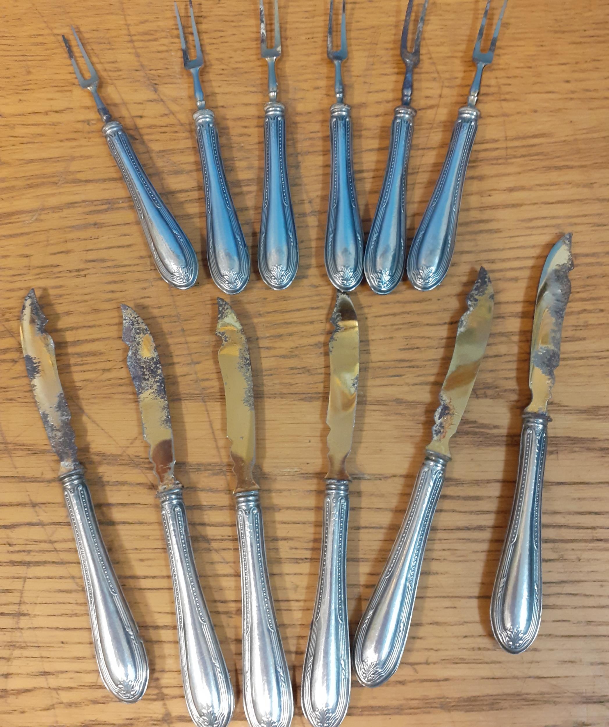 A set of six white metal pickle forks and knives Condition: Tarnishing to the blades - see photos