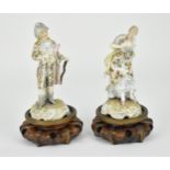 A pair of 19th century German porcelain figures, modelled as a lady and gentleman, both well groomed