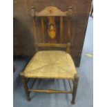 A late Victorian/early 20th century child's chair with rattan seat, inlaid with a depiction of a