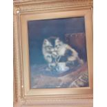 An unsigned oil on canvas of a kitten sitting behind a jug of milk and licking its paw, in a gilt
