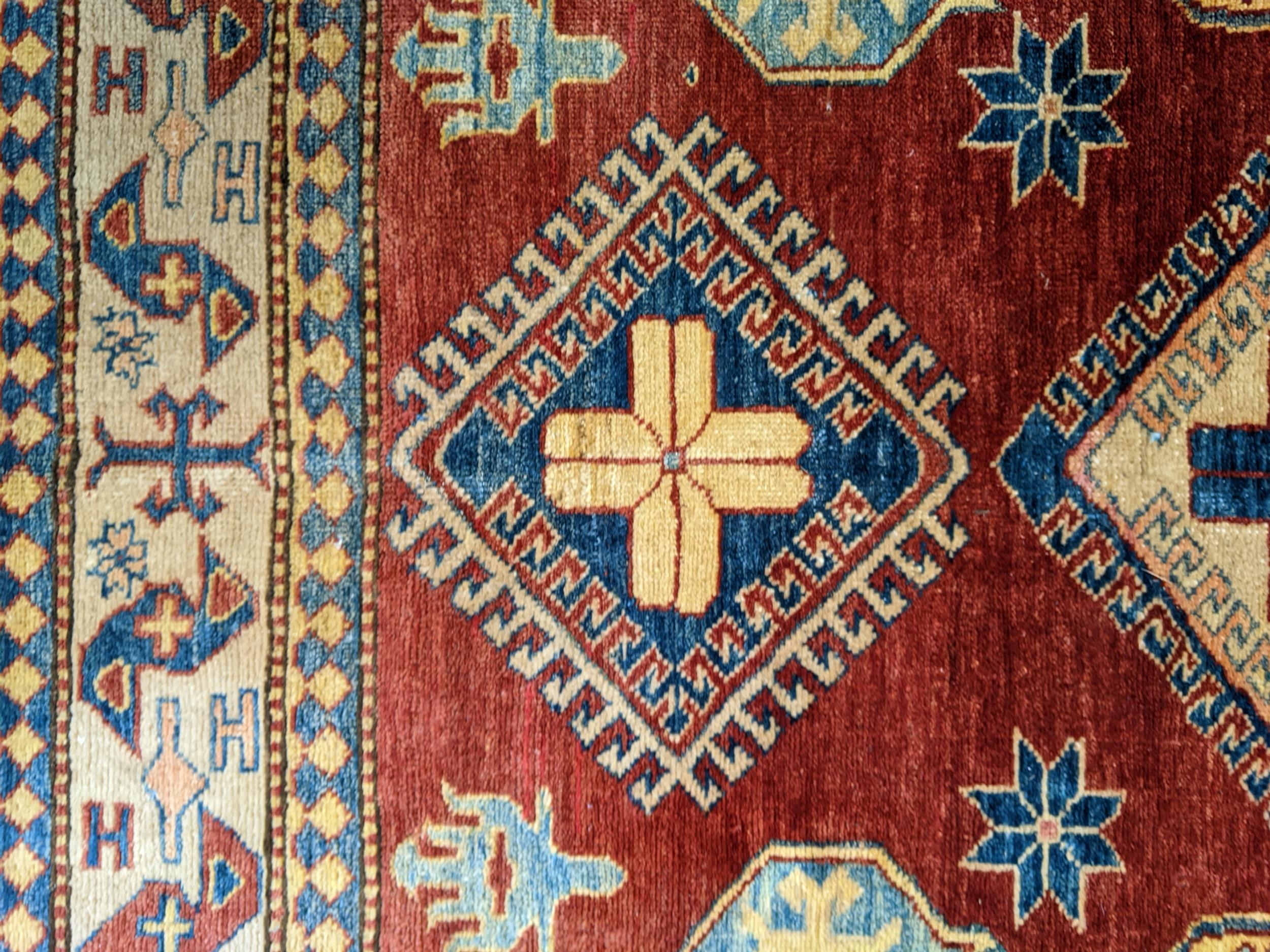 A Caucasian design Turkish rug with geometric motifs on a beige ground 160cm x 134cm - Image 2 of 3