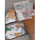 Two boxes of worldwide franked stamps together with four worldwide stamp albums and contents