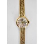 A vintage ladies 9ct gold cased Tissot manual wind wristwatch, having a silvered dial with baton