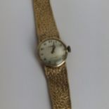 A vintage ladies 9ct gold cased manual wind Tissot wristwatch having a silvered dial, signed