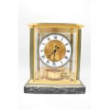 A Jaeger LeCoultre Atmos clock, the glass and brass case with green enamel highlights and corner