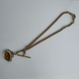 A 9ct gold watch chain with two dog clops and T-bar, together with a yellow metal chain containing a