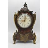 A late 19th/early 20th century French Boulle mantle clock, the red tortoiseshell case having a metal