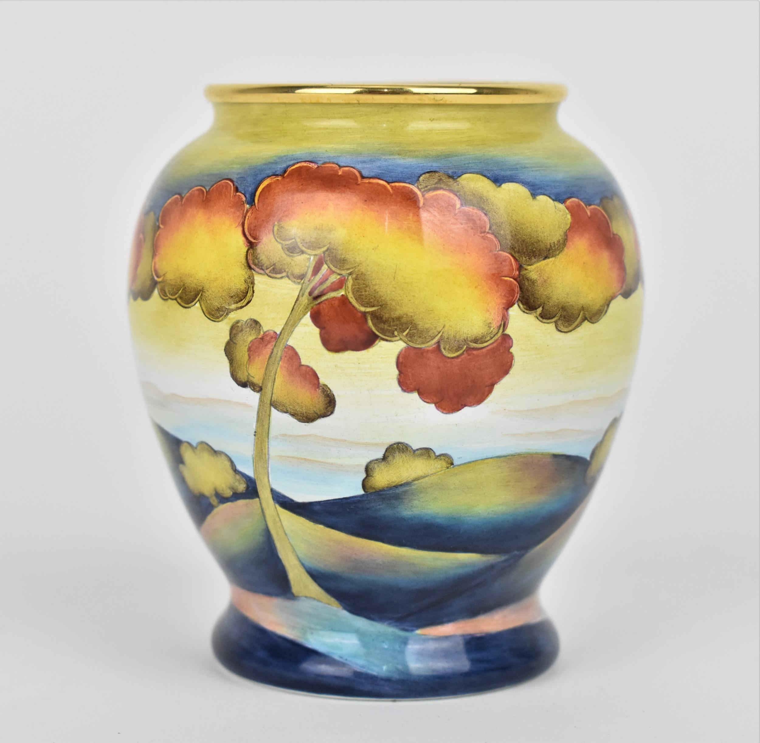 A limited edition Moorcroft Enamels Ltd miniature baluster vase in the 'Hazledene Sunset' by Carol