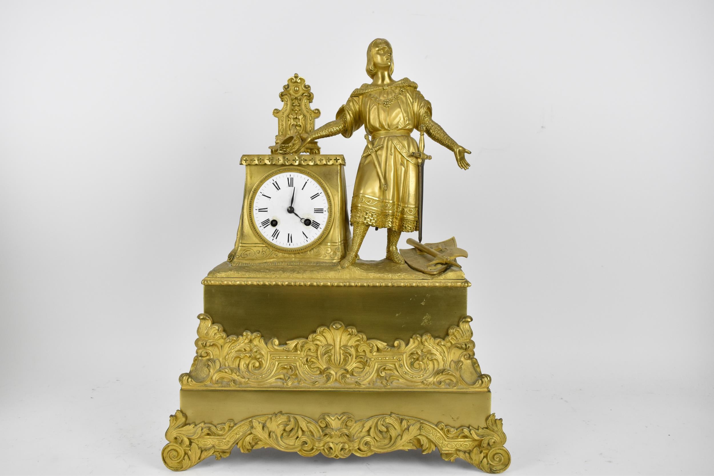 A 19th century French brass cased 8 day mantle clock, the case decorated with a figure, possibly