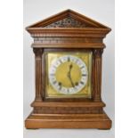 A late 19th century Winterhalder & Hofmeier 8 day mantle clock, the oak case of architectural