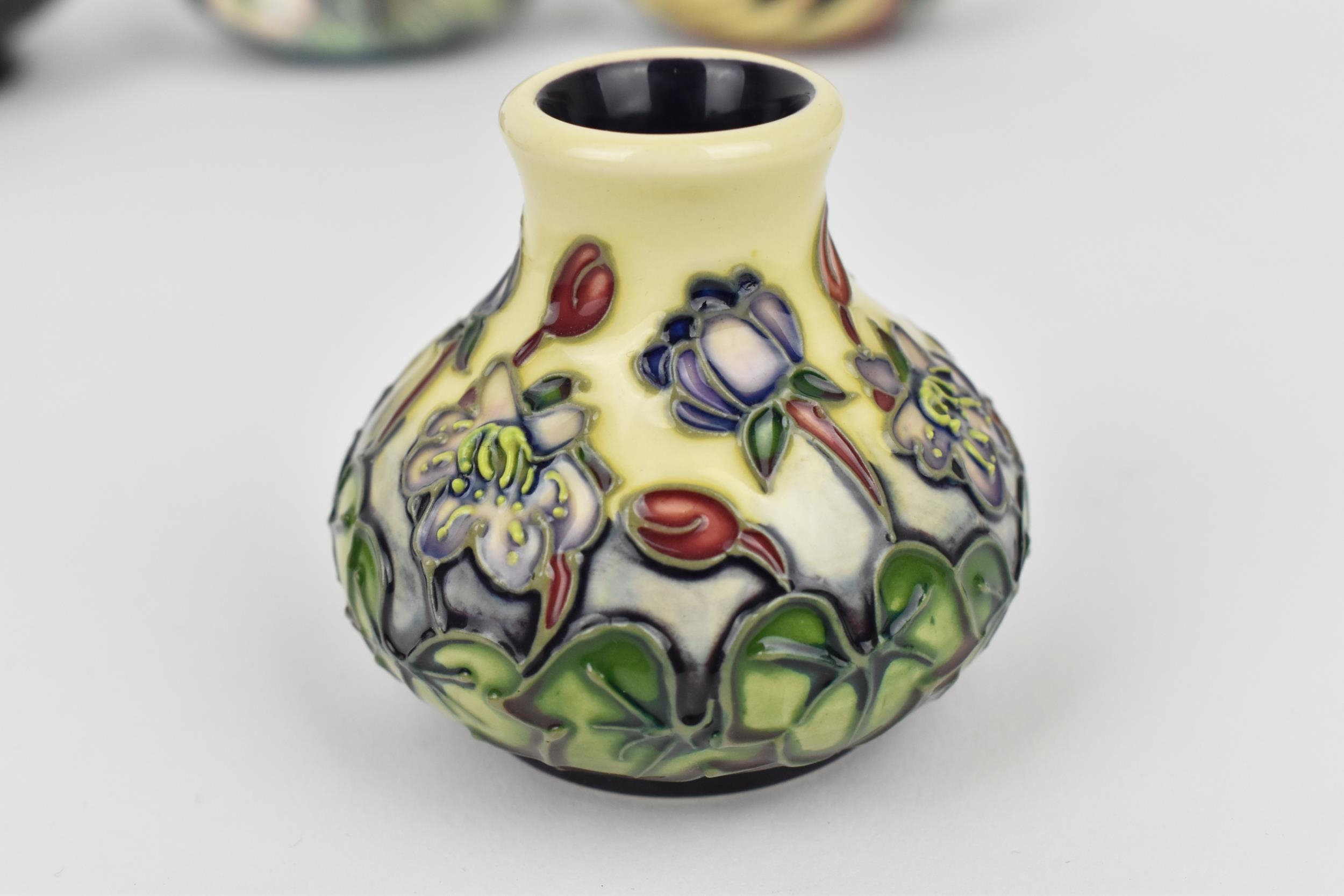 A small collection of Moorcroft ceramics, to include a squat vase in the 'Clematis' pattern on green - Image 2 of 7