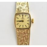 A vintage ladies 9ct gold cased manual wind Omega wristwatch having a signed dial with baton hour