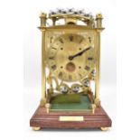 A late 20th century brass spherical weight clock, by Harding & Bazeley, Cheltenham, England, the