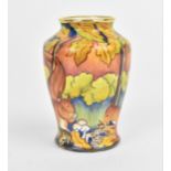 A Moorcroft Enamels Ltd miniature baluster vase, painted with squirrels foraging, with artists