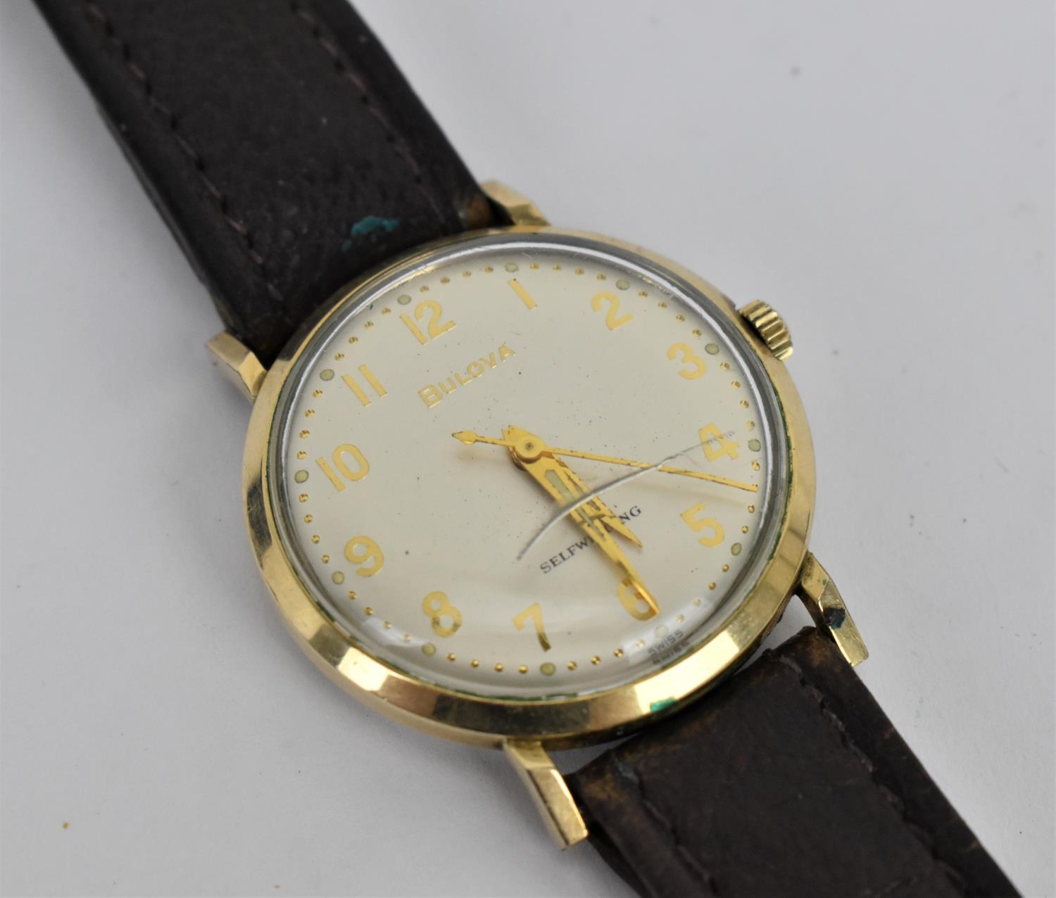 A vintage 1964 gents gold plated Automatic Bulova having a silvered dial with Arabic numerals and