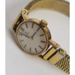 A ladies circa 1974 9ct gold manual wind Omega having a silvered dial with baton hour markers, the