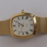 A gents 9ct gold cased quartz Longines wristwatch having a rectangular white enamel dial signed